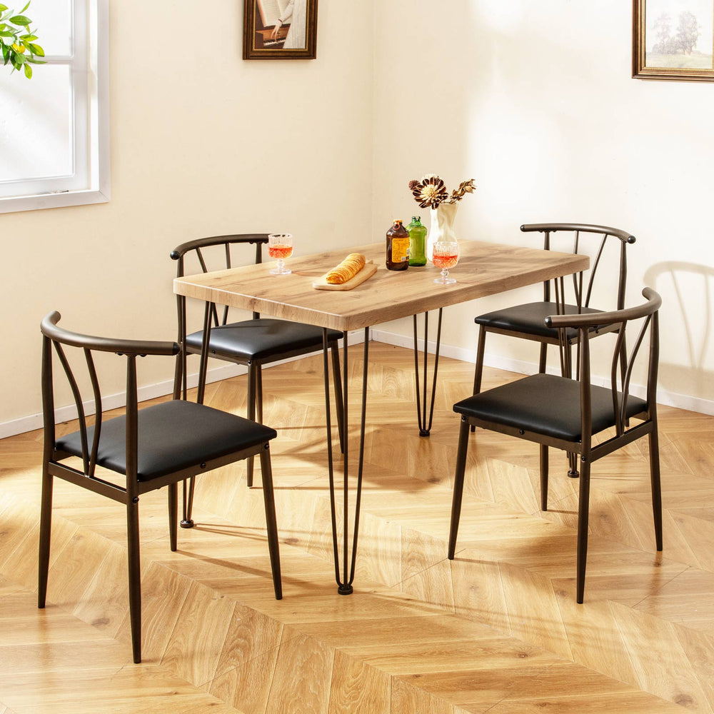 5-piece industrial dining table set with black armless chairs, featuring a wood-like veneer and sturdy metal legs.