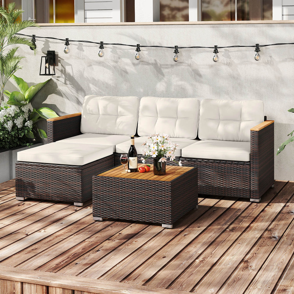 5-piece wicker conversation set with white cushions and acacia wood tabletop, perfect for outdoor patio relaxation.