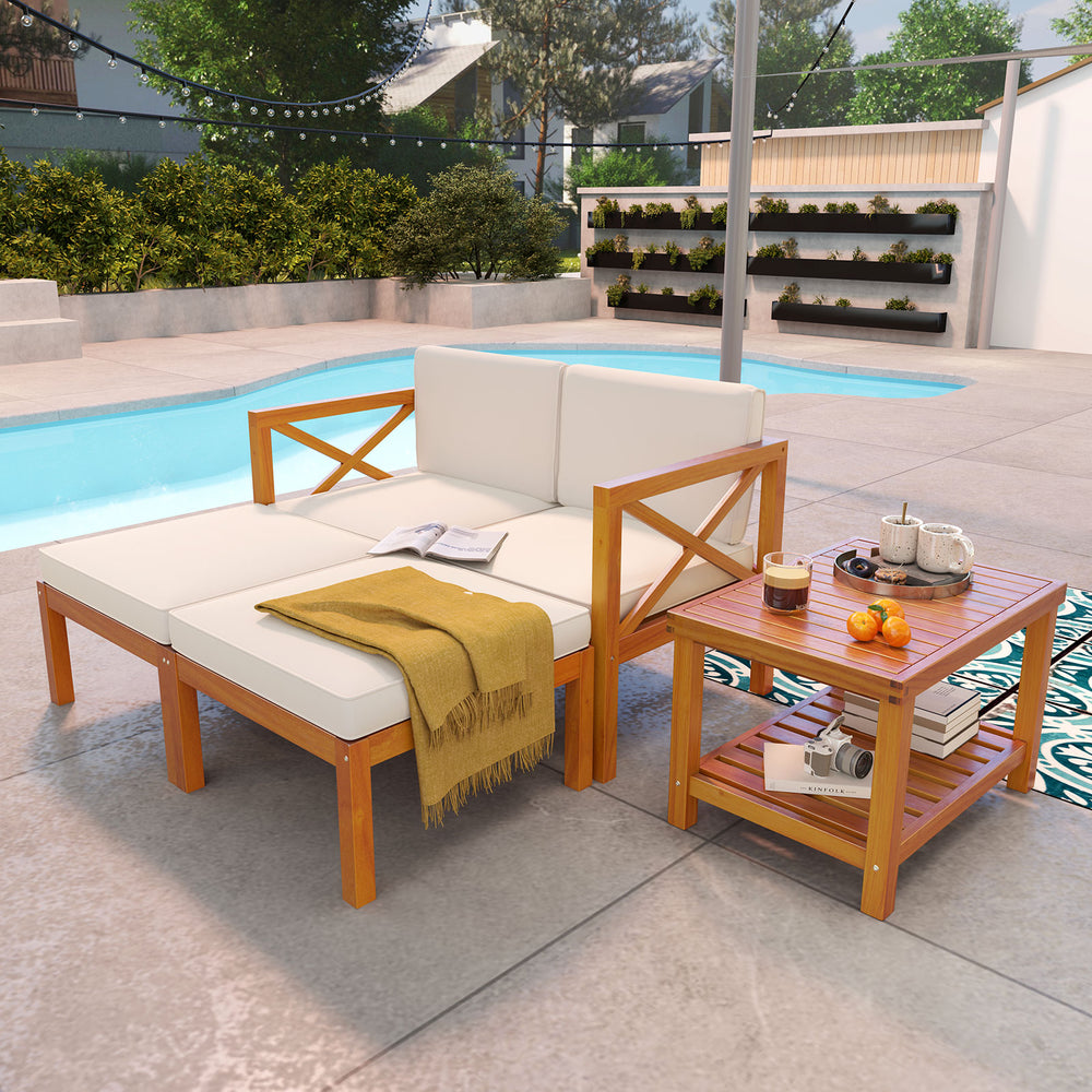 Acacia wood patio lounge chair set with white cushions, featuring a coffee table, ideal for outdoor relaxation by the.