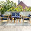 5-piece outdoor conversation set featuring navy cushions, acacia wood frame, and two coffee tables for poolside.