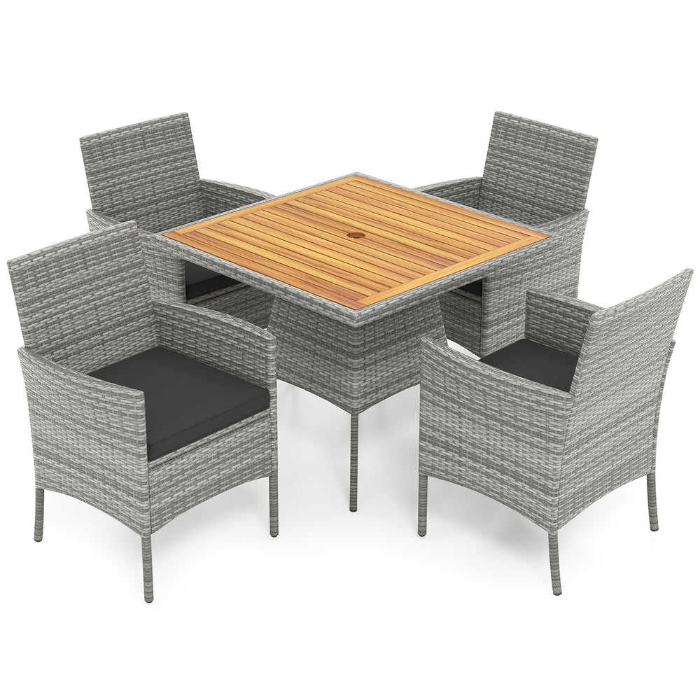 5-piece PE wicker patio dining set with acacia wood table and black cushions, perfect for outdoor dining and relaxation.