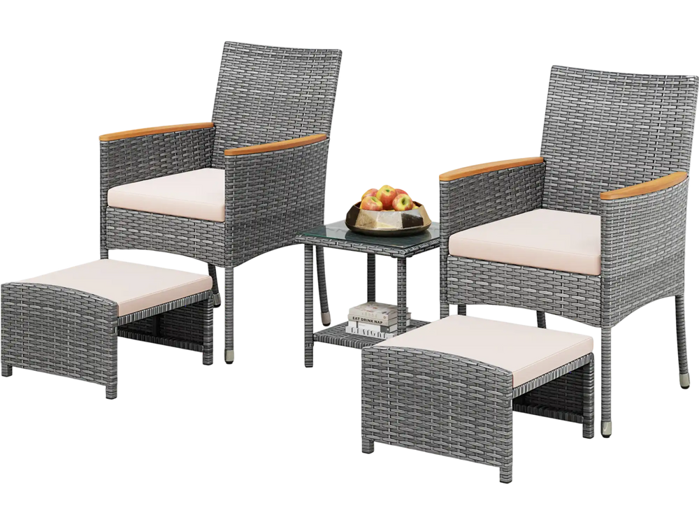 Patio conversation set featuring two armchairs, ottomans, and a glass table, crafted from grey PE rattan for outdoor.