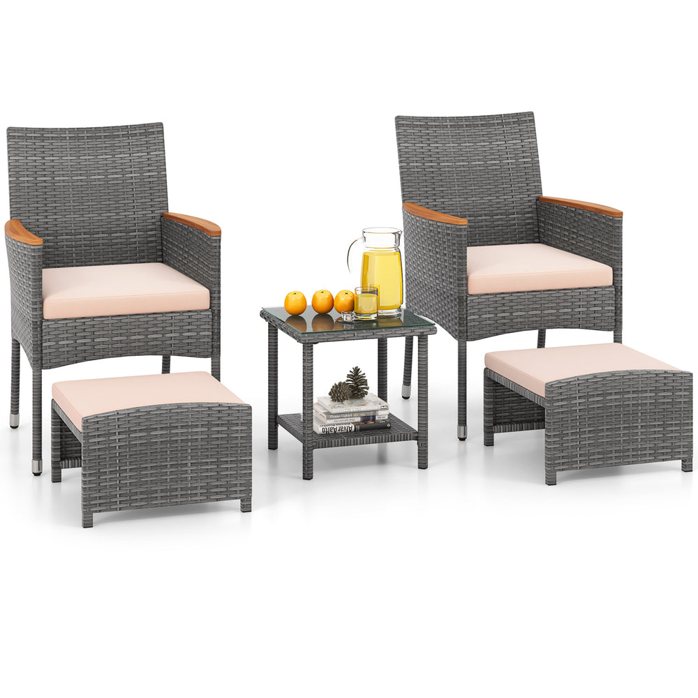 Patio conversation set featuring two armchairs, ottomans, and a side table with soft beige cushions for outdoor.
