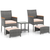 Patio conversation set featuring two armchairs, ottomans, and a side table with grey PE rattan and soft beige cushions.