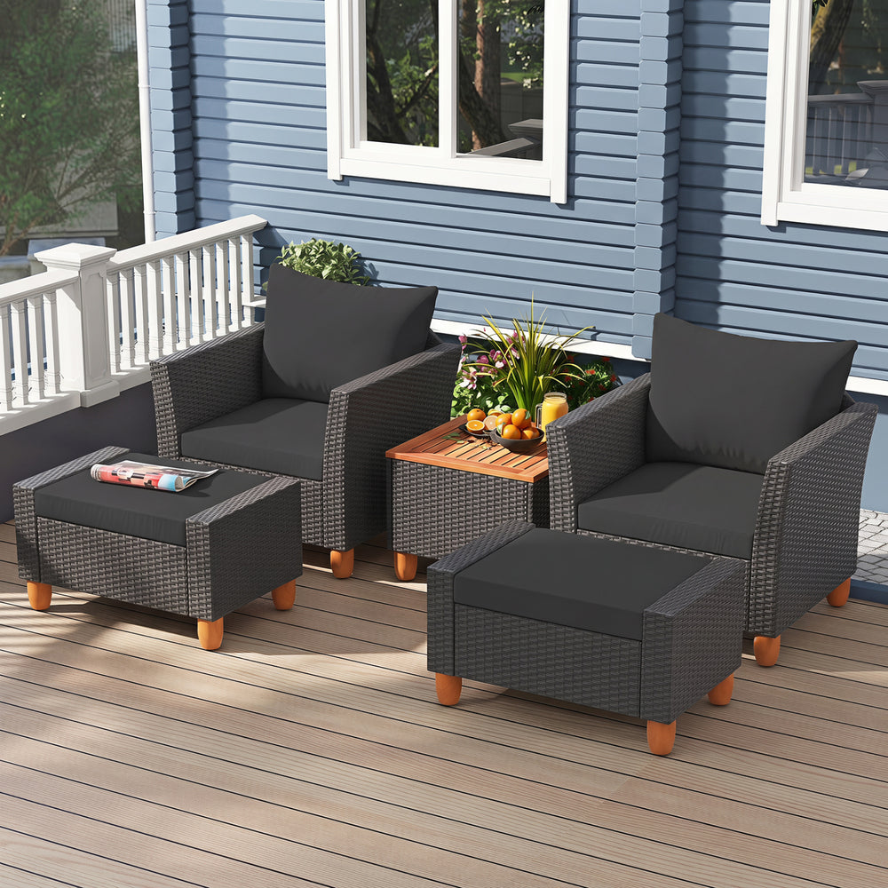 Patio furniture set featuring black armchairs, loveseat, and storage table, perfect for outdoor relaxation and gatherings.
