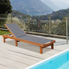 Adjustable outdoor wood chaise lounge chair with breathable fabric, perfect for sunbathing by the poolside.