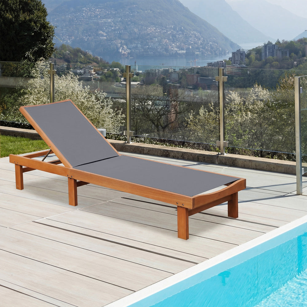 Adjustable outdoor wood chaise lounge chair with breathable fabric, perfect for sunbathing by the poolside.