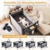 Portable 5 in 1 baby pack and play in black features adjustable height, safety strap, and includes a music box and toys.