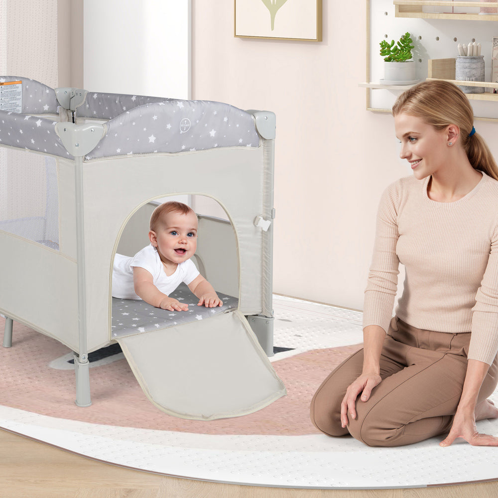 Portable 5-in-1 baby beside sleeper bassinet in beige with zipper door, changing station, and flexible wheels for easy.