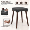 Upholstered stool with padded seat in PU leather and rubber wood legs, perfect for dining or kitchen use.