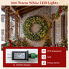 60-inch pre-lit artificial Christmas wreath with 200 warm white LED lights, showcasing frosted branch tips and pine.