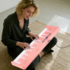 Pink 61-key foldable piano keyboard with MIDI function, featuring a wood grain surface and dual keyboard for duet.