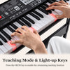 61-key electric keyboard with light-up keys and teaching mode, perfect for beginners, shown with hands on the keys.