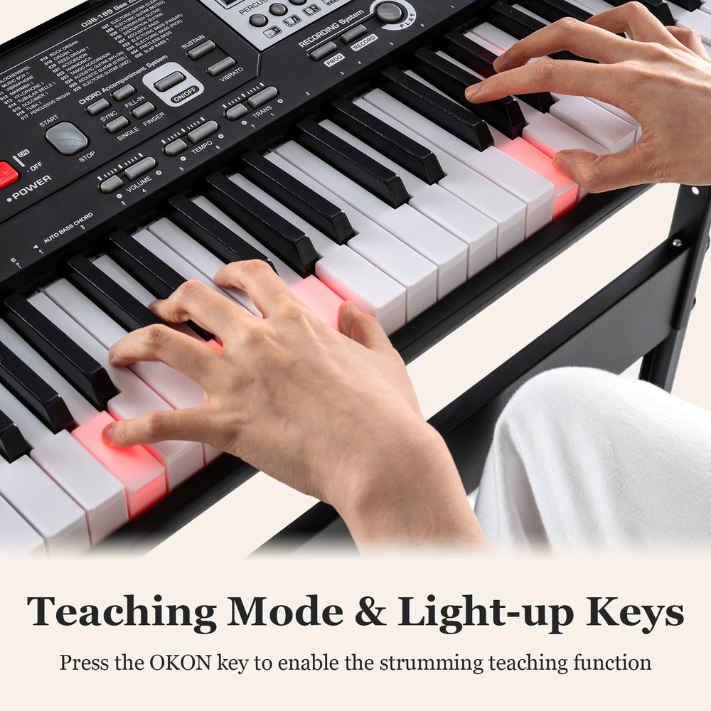 61-key electric keyboard with light-up keys and teaching mode, perfect for beginners, shown with hands on the keys.