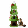 Green 62-inch Christmas cat tree front view with snowy accents, three cozy condos, and hanging balls beside a cat.