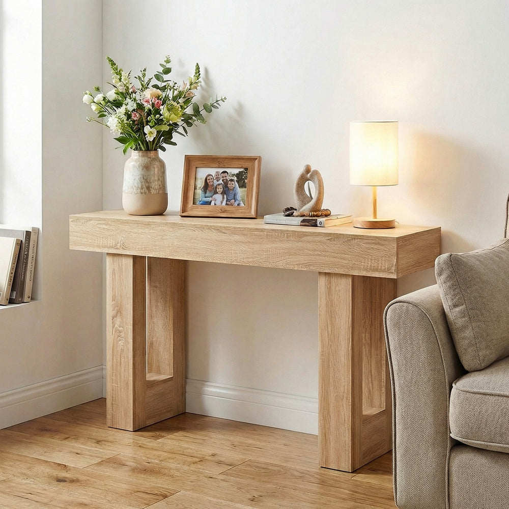 Console table with natural wood grain, 63" long, featuring sturdy legs and ample storage for entryway or living room.