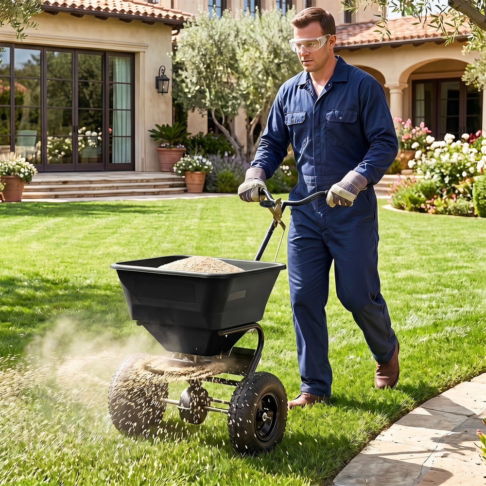 Walk-behind broadcast spreader with a 66 lbs capacity and 13-inch all-terrain tires for efficient lawn care and spreading.