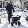 Walk-behind broadcast spreader with 66 lbs capacity, 13-inch all-terrain tires, ideal for efficient snow and lawn spreading.