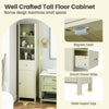 Tall beige bathroom cabinet with fluted door, three shelves, and pull-out drawer for efficient small space storage.