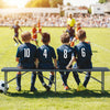 Portable 6 feet gray plastic folding bench with handle, accommodating up to 4 people for outdoor events like soccer.