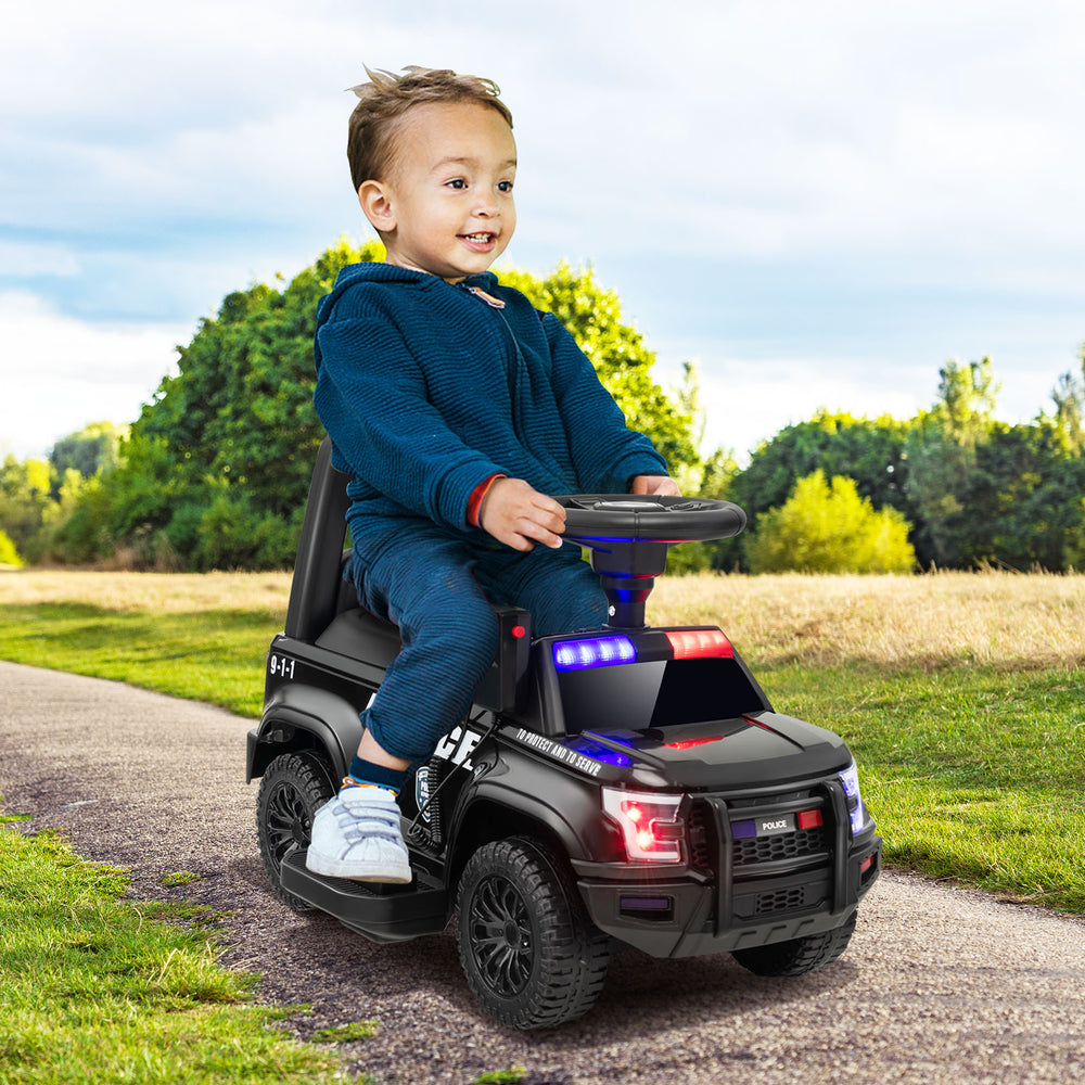 Kids ride-on police car in black with flashing lights, megaphone, and sturdy wheels for a fun outdoor experience.