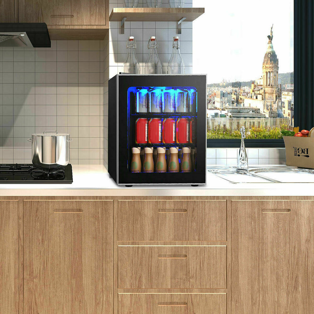 Mini beverage refrigerator with glass door, holding 60 cans, featuring LED light and compact design for small spaces.