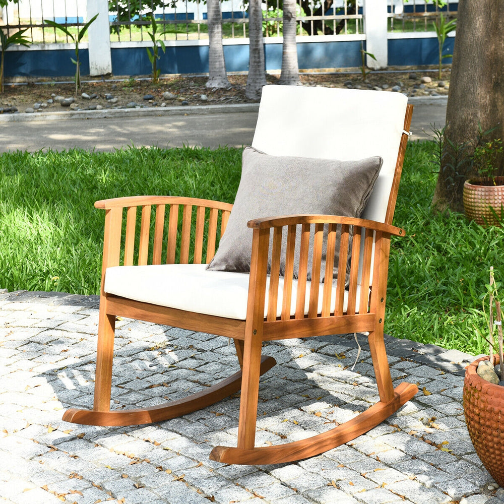 Acacia wood rocking chair with detachable cushions, featuring a rustic teak color, perfect for patio or garden.