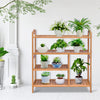 Four-tier bamboo storage shoe rack showcasing plants, ideal for entryway or hallway organization and decor.