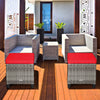 Two-piece patio rattan ottomans with removable red cushions, perfect for outdoor use in gardens or poolside settings.