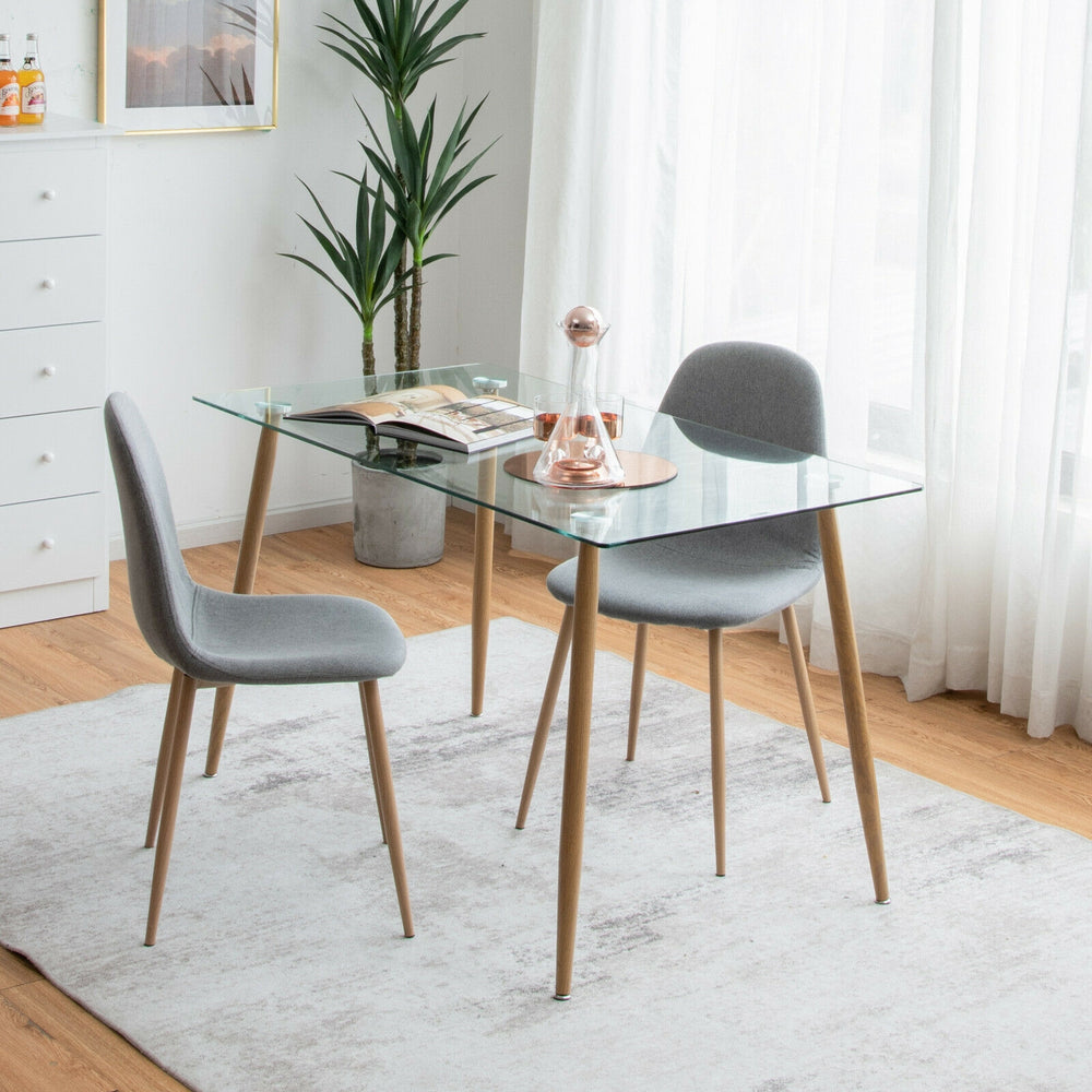 Modern glass rectangular dining table with wood grain imitation legs, perfect for home or office use.