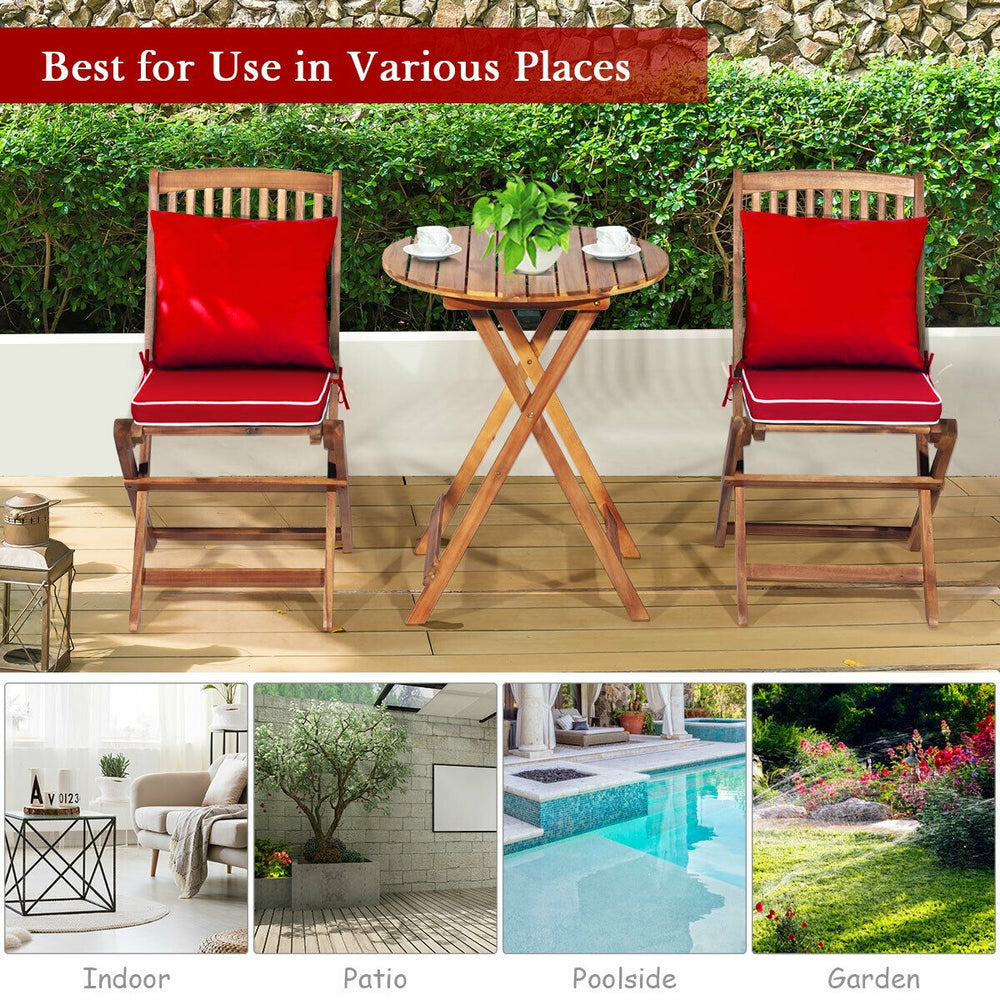 Folding bistro set with red padded cushions and round coffee table, made of solid acacia wood for outdoor use.