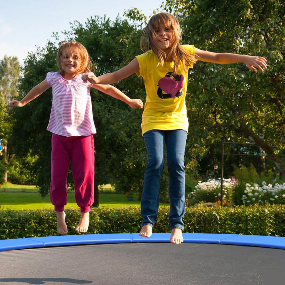 Two children jumping on a trampoline with a blue safety pad, designed for edge-to-edge protection and weather.