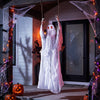 Swinging ghost decoration with light-up red eyes, perfect for Halloween scares on porches or indoor spaces.