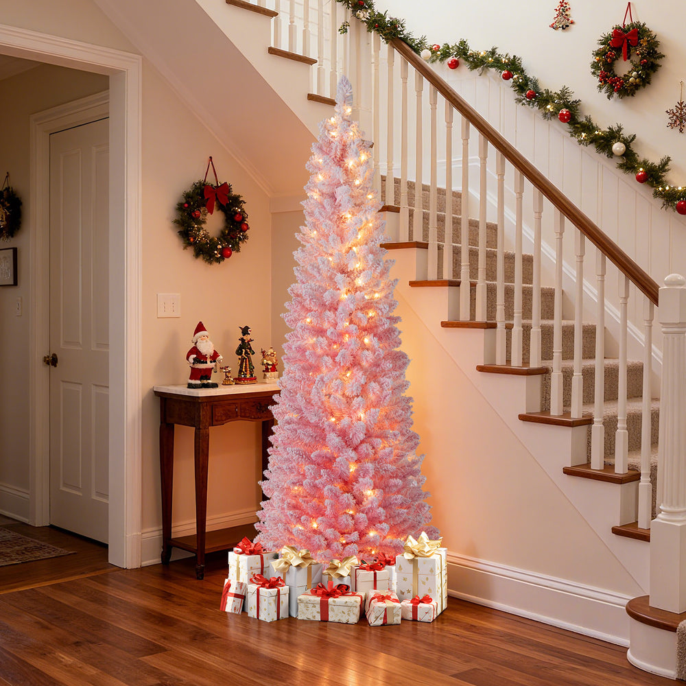 Snow-flocked 6 FT pink Christmas tree with warm white LED lights, perfect for holiday decoration in any home.