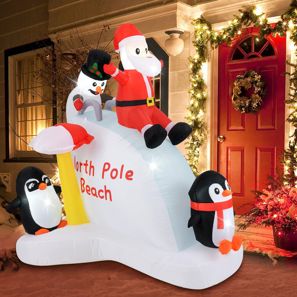 6-foot Christmas inflatable featuring Santa and penguins on an ice slide, with LED lights for festive outdoor.