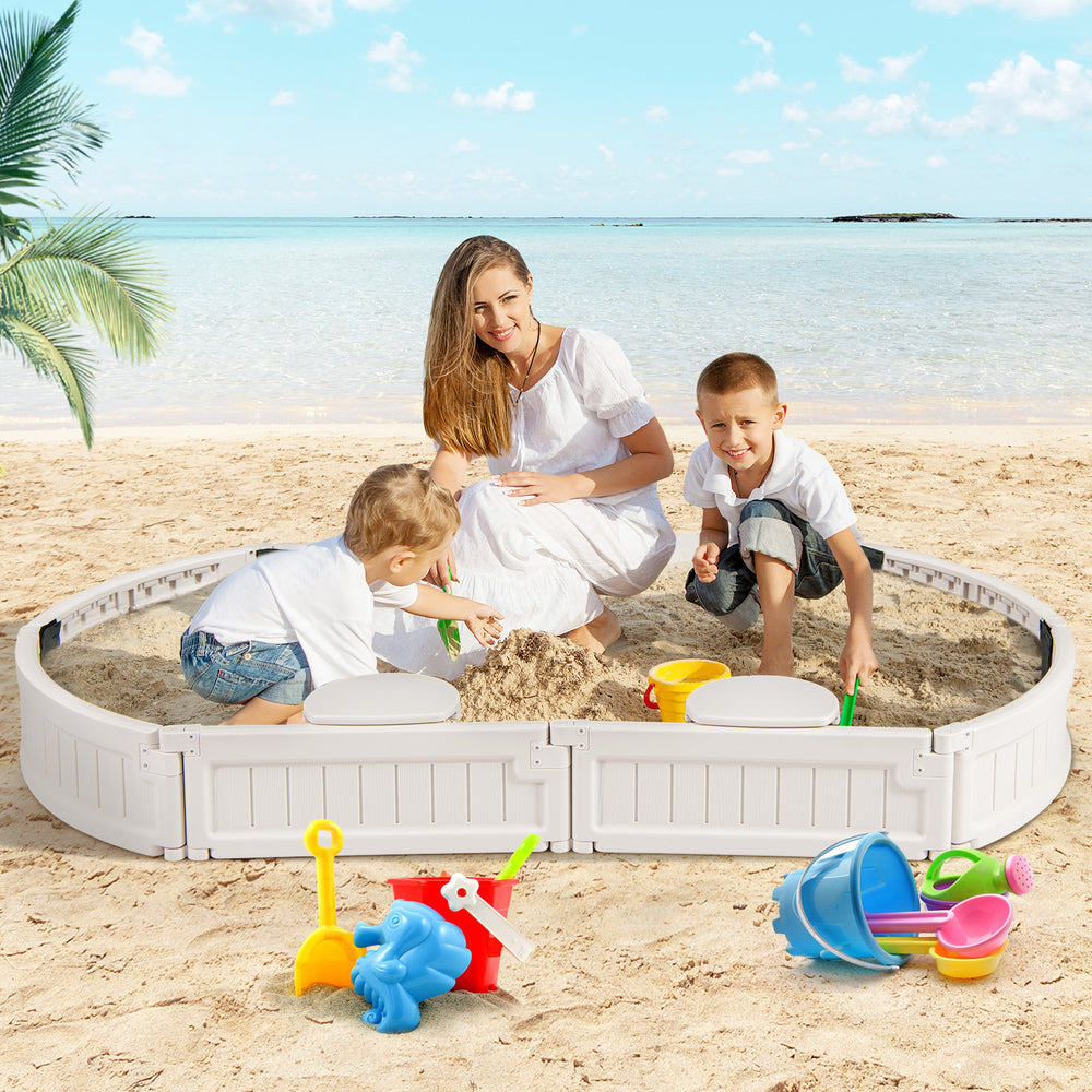 Kids playing in a 6 feet oval sandbox with built-in corner seats, featuring a dust-proof cover for outdoor fun.