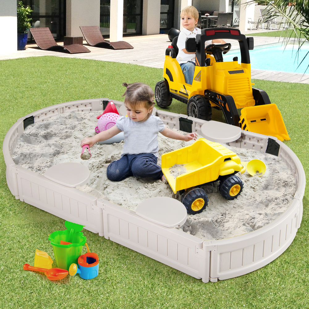 Kids playing in a 6 feet oval sandbox with built-in corner seats, featuring a dust-proof cover and weather-resistant.