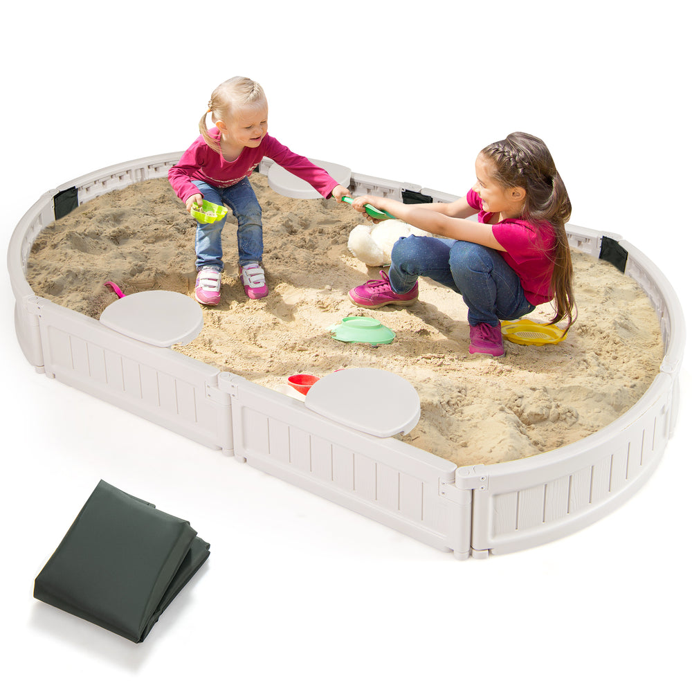 Top view of the 6 feet kids oval sandbox with sand, built-in corner seats, and dust-proof cover for outdoor enjoyment.