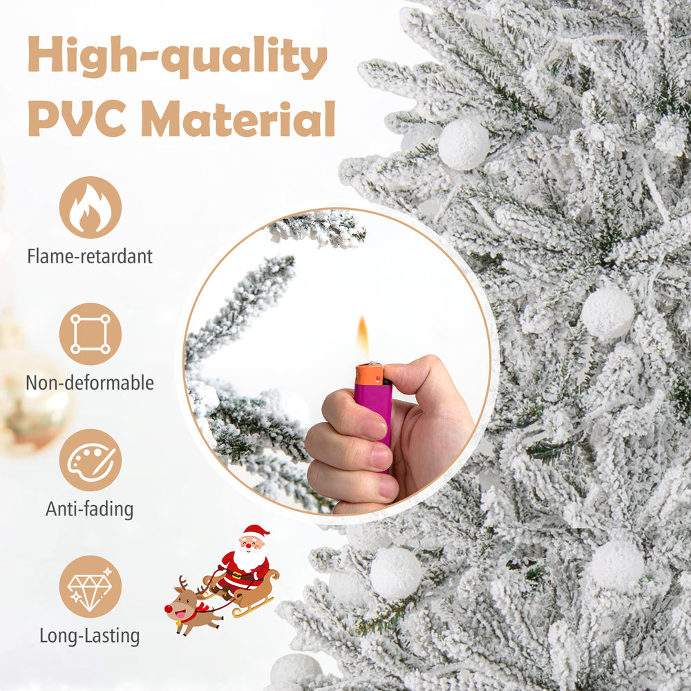 Close-up of a hand holding a lighter near a snow-flocked artificial Christmas tree made of flame-retardant PVC material.