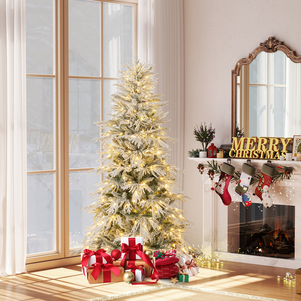 Snow-flocked 6 feet artificial Christmas tree with warm white LED lights, decorated with gifts and a cozy fireplace.