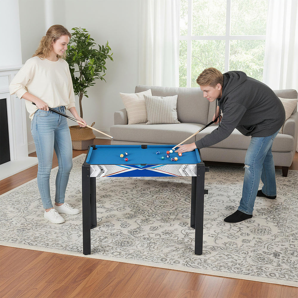 Players enjoying the 6-in-1 combo game table featuring billiards, basketball, and more in a stylish living room setting.