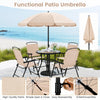 Patio dining set with beige umbrella and four folding armchairs, featuring a glass tabletop for outdoor comfort and style.