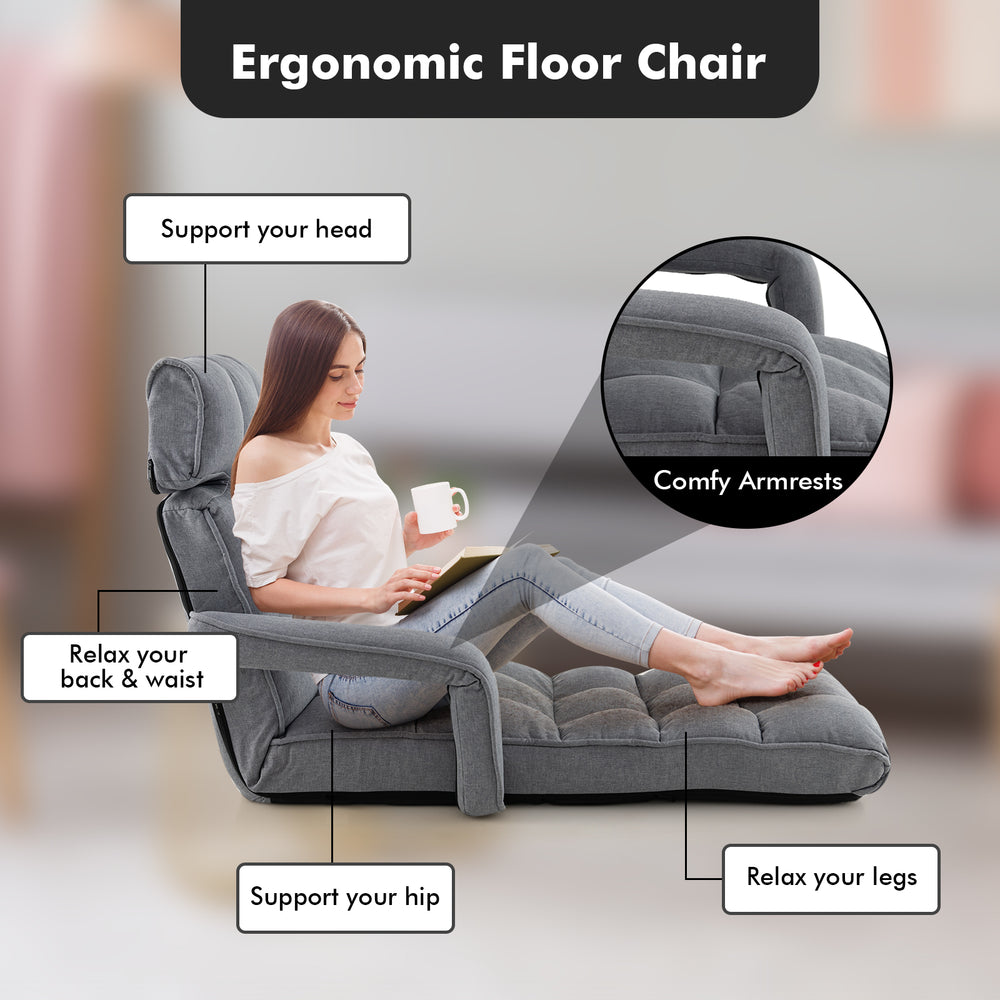 Adjustable gray floor chair with armrests and footrest, perfect for relaxing in living rooms or bedrooms.