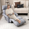 Adjustable gray floor chair with armrests and footrest, perfect for relaxation in living rooms or bedrooms.