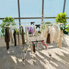 Portable laundry drying rack with adjustable wings, made of rust-proof steel, ideal for efficient clothes organization.