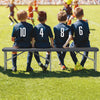Gray 6 feet folding HDPE bench with wood-like texture, accommodating up to 4 people for outdoor events like soccer.