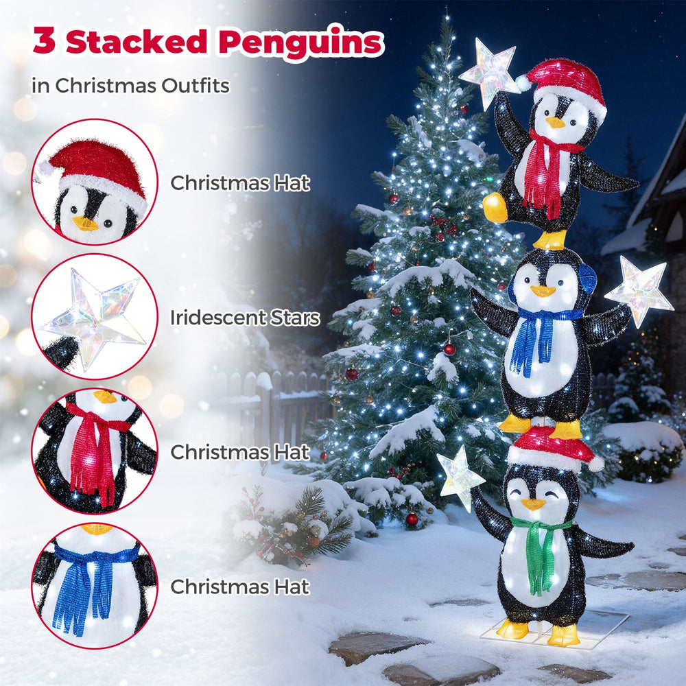 Three stacked penguins in Christmas hats and scarves hold iridescent stars, illuminated by cold white LED lights for holiday cheer.
