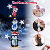 Three stacked penguins with Christmas hats and scarves, illuminated by cold white LED lights for festive yard decor.