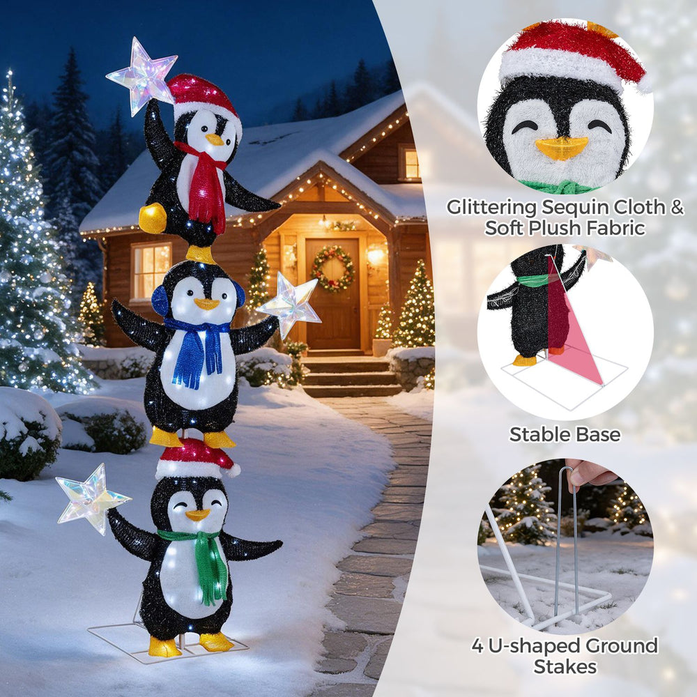 Three stacked penguins in Christmas hats and scarves, illuminated by LED lights, create festive holiday cheer for outdoor decor.