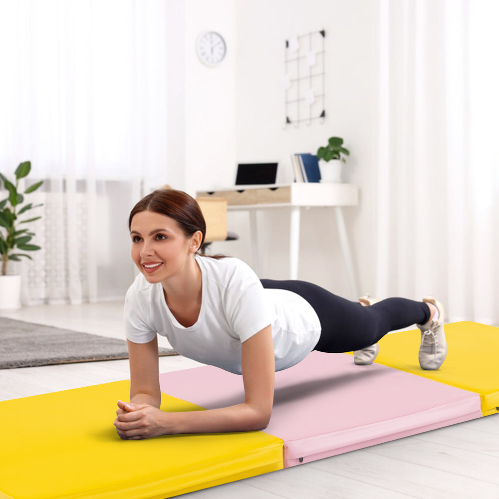 Tri-fold gym mat in yellow with a woman performing a plank, ideal for yoga and martial arts, featuring a removable.